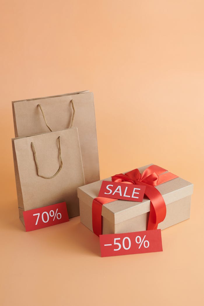 Image of shopping bags and a gift box with discount tags, perfect for sales promotion.
