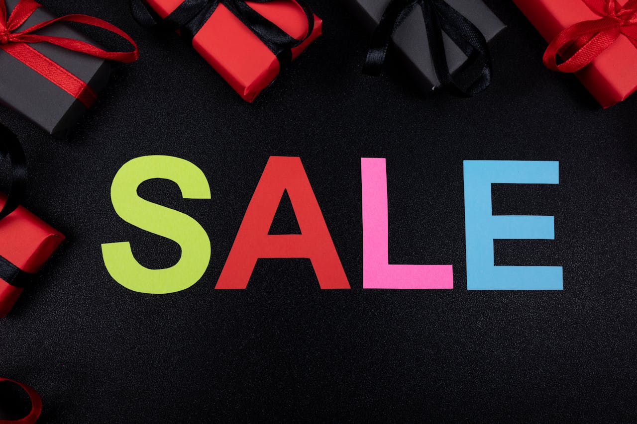 Vibrant SALE text surrounded by gift boxes offers perfect promotional imagery.